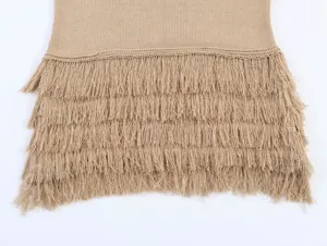 Close-up detail of stylish khaki knit apparel featuring multi-layered fringe hem texture.