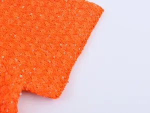 Oranger Pailletten Stricktop Detailaufnahme, metallischer Faden und Nahansicht Textur.