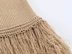 Detail shot of women's knitted camisole top featuring trendy fringe hem and texture.