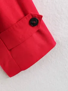 Red trench coat sleeve detail, buttoned flap design, premium fabric texture close-up.