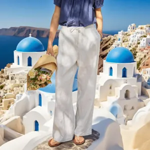 Detailed view of women's white cotton drawstring wide-leg casual pants in a beach resort setting.