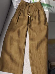 Brown cotton casual wide leg pants with elastic drawstring waist and pleated details for summer.