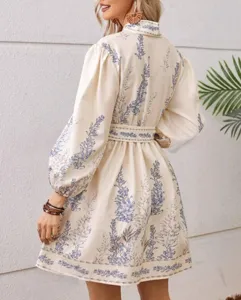 Detail view of women's long sleeve floral print dress back design, bohemian style fabric.