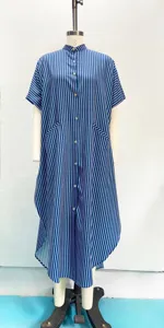 Blue and white vertical striped detail of the loose shirt dress with button front and short sleeves.
