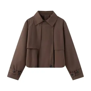Brown cropped trench jacket detail showing lapel collar, raglan sleeves and button cuffs.