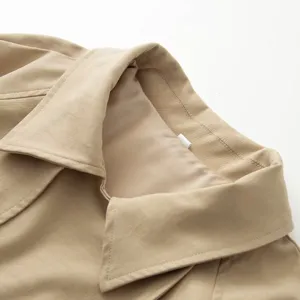 Close-up shot of the elegant beige trench coat lapel and collar detail, premium fabric texture.