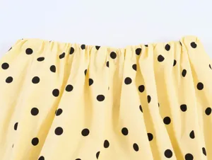 Yellow black polka dot fabric detail shot, elastic pleated neckline design, summer style.