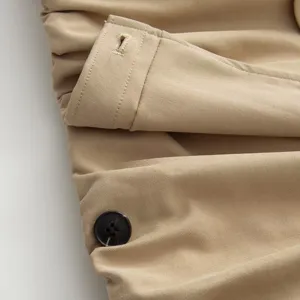 Khaki trench coat sleeve detail, classic button and cuff design, elegant fashion outerwear.