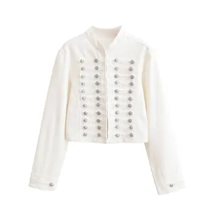 Close-up of the elegant white military-style cropped jacket featuring intricate silver buttons.