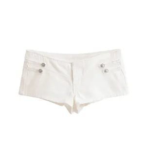 Detailed view of white denim hot pants featuring metallic decorative buttons and pleated side design.