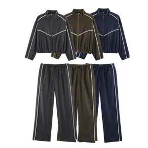 Women casual contrast piping zip-up jacket and long pants tracksuit set detail view.