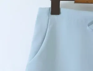 Light blue skirt pocket and seam detail close-up view showcasing fabric texture.
