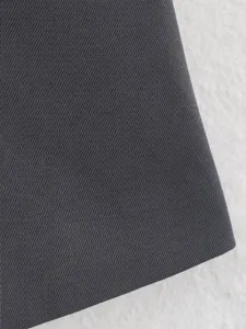 Dark grey twill fabric detail closeup for women fashion slim sleeveless vest apparel.