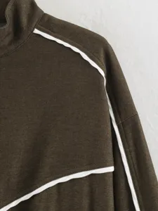 Close-up detail view of a stylish brown women stand collar jacket with white contrast piping.