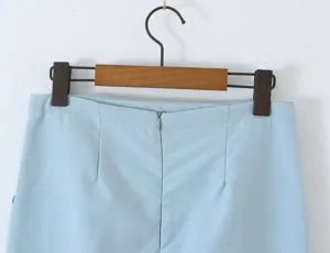 Light blue skirt detail featuring clean waist stitching, back zipper and fitted darts.