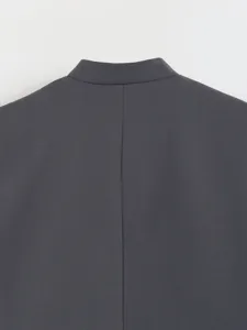 Close-up detail of the back collar and seam of a stylish dark grey women vest waistcoat.