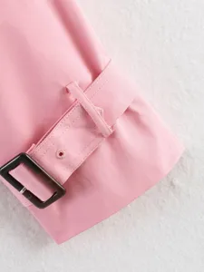 Pink trench coat sleeve detail with tortoiseshell buckle and stylish matching belt strap.