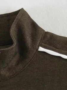 Detailed shot of women mock neck jacket collar with white contrast piping trim design.