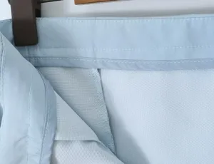 Light blue women garment detail showing fine stitching and breathable inner lining fabric structure.