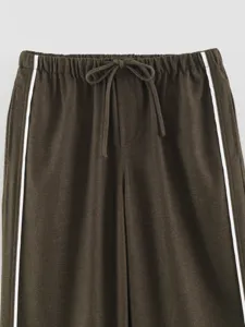 Casual brown trousers detail featuring white side stripes and a comfy drawstring elastic waist.