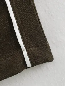 Close-up detail of women clothing contrast color trim stitching fabric texture macro shot.