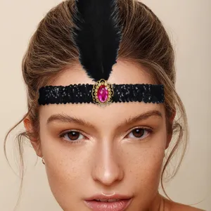 Close-up of 1920s vintage black sequin feather headband with pink crystal and gold base detail.
