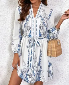 Chic V-neck long sleeve dress with blue botanical print, featuring a stylish waist belt detail.