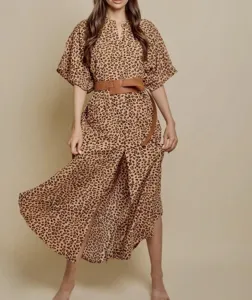 Detailed shot of women's leopard print beach dress, batwing sleeve design with stylish belt.