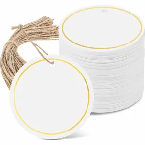 Round paper tags blank gift cards with gold foil border and twine for DIY wedding decoration.