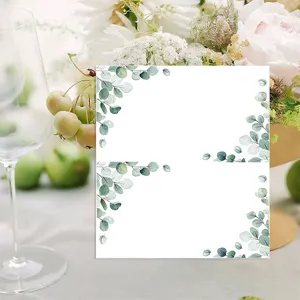 Detailed view of blank watercolor eucalyptus folded place cards styled on a wedding dinner table.