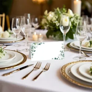 Elegant folded place cards with eucalyptus watercolor design for wedding party table setting.
