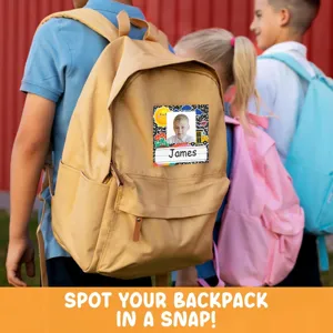 Detailed view of personalized student name sticker with photo attached to a classic backpack.