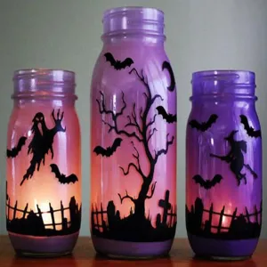 Halloween decorative glass jar lantern with purple gradient and spooky silhouette designs.