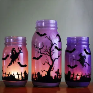 Halloween decorative glass jars with bat and ghost silhouette designs for spooky home decor