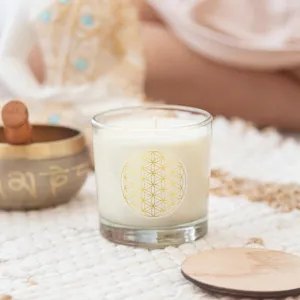Scented candle in glass jar with golden sacred geometry flower of life sticker for home decor