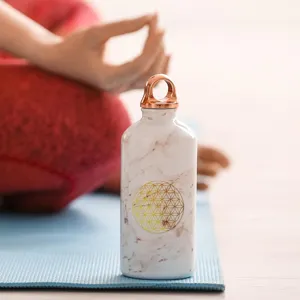 Marble pattern water bottle with gold sacred geometry flower of life symbol and metal ring lid.