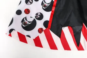 Close-up detail of Halloween vampire clown costume fabric with polka dot clown print and stripes.
