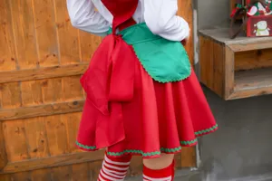 Detailed view of the Christmas cosplay costume showing the back bow, green apron and red skirt.
