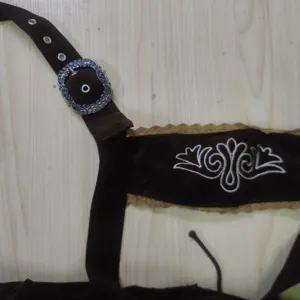 Detail view of German Oktoberfest traditional men costume suspenders with vintage embroidery.