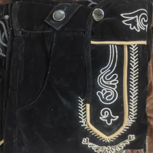 Detailed view of traditional German Oktoberfest men's embroidered leather shorts costume.