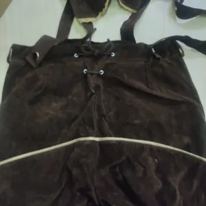 Men's German Oktoberfest Lederhosen brown suede suspender shorts costume detail view.