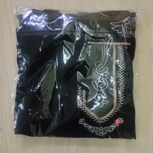Detailed view of traditional embroidered men's festival costume folded in packaging bag.