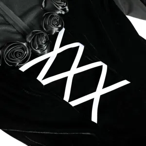 Black velvet gothic cosplay costume detail featuring satin roses and white ribbon lace up design.