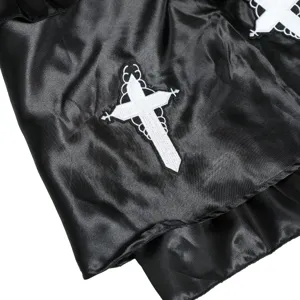 Vampire nun cosplay costume detail black satin fabric with gothic white cross embroidery.