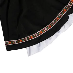 German Oktoberfest dress skirt detail featuring traditional floral embroidery ribbon trimming.