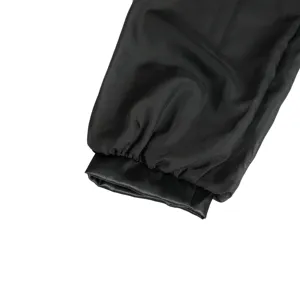 Detailed view of the black costume sleeve cuff featuring mesh and satin panel design.
