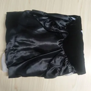 Detailed shot of folded black satin and velvet costume piece for cosplay events.