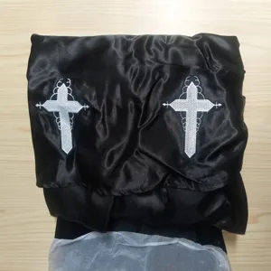 Gothic black satin nun costume detail with white cross embroidery for Halloween cosplay events.