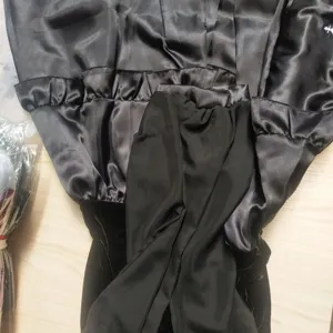 Detail shot of black satin and velvet gothic nun cosplay costume for Halloween events.