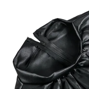 Black satin costume detail close-up showing fine zipper closure and smooth fabric texture.